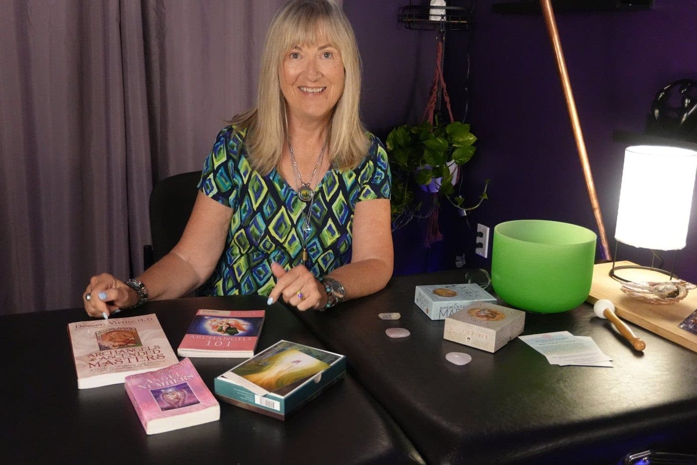 Anne Murray at her reading table with angel cards, books and a crystal bowl