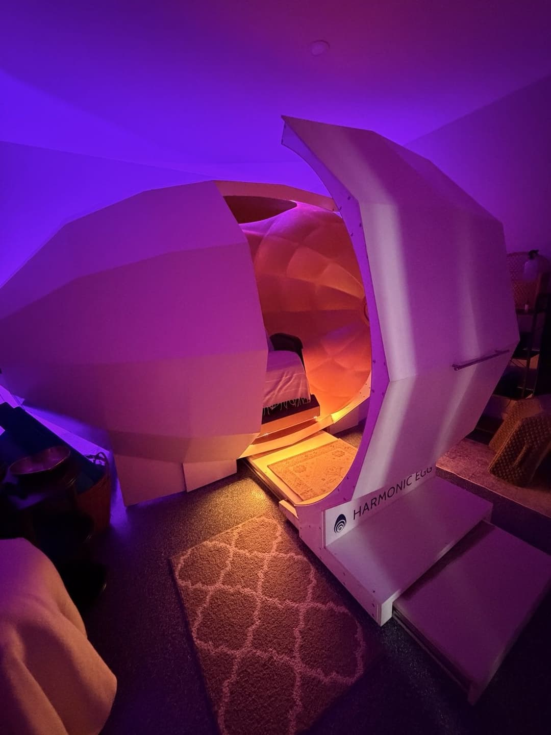 The Harmonic Egg chamber lit amber and violet in Ark 1
