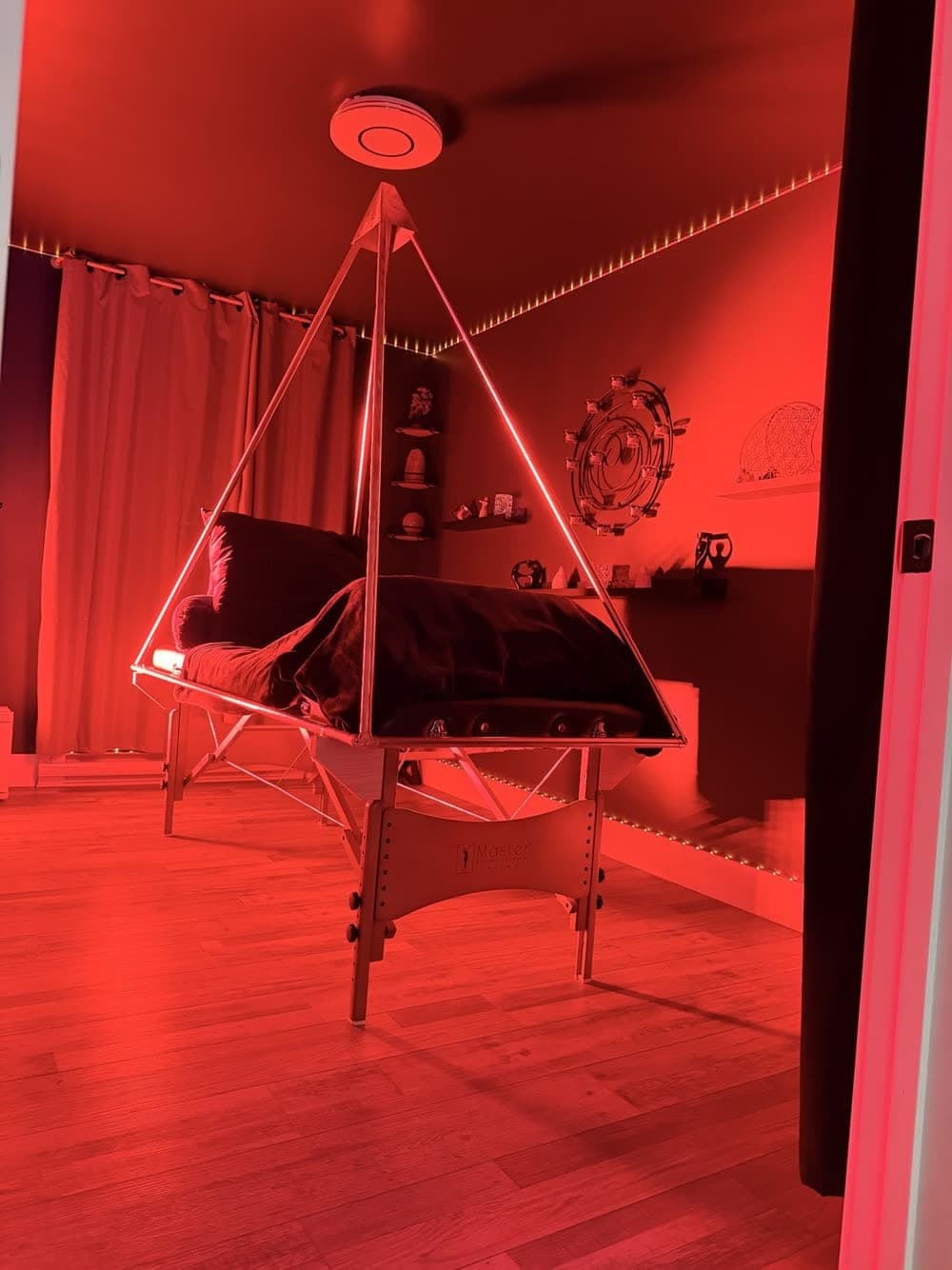 The copper pyramid under red light in the Quantum Room